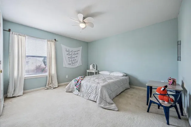 a bedroom with a bed and chair