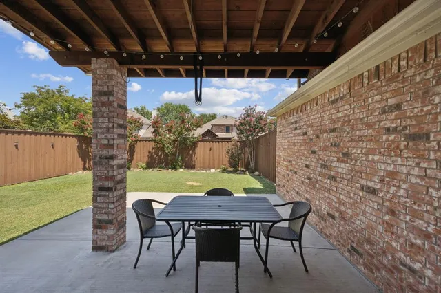 a view of a porch with furniture and yard