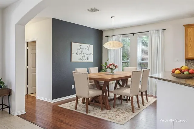 a view of a dining room with furniture and wooden floor