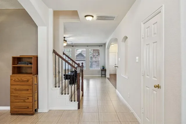 a view of hallway with stairs and wooden floor
