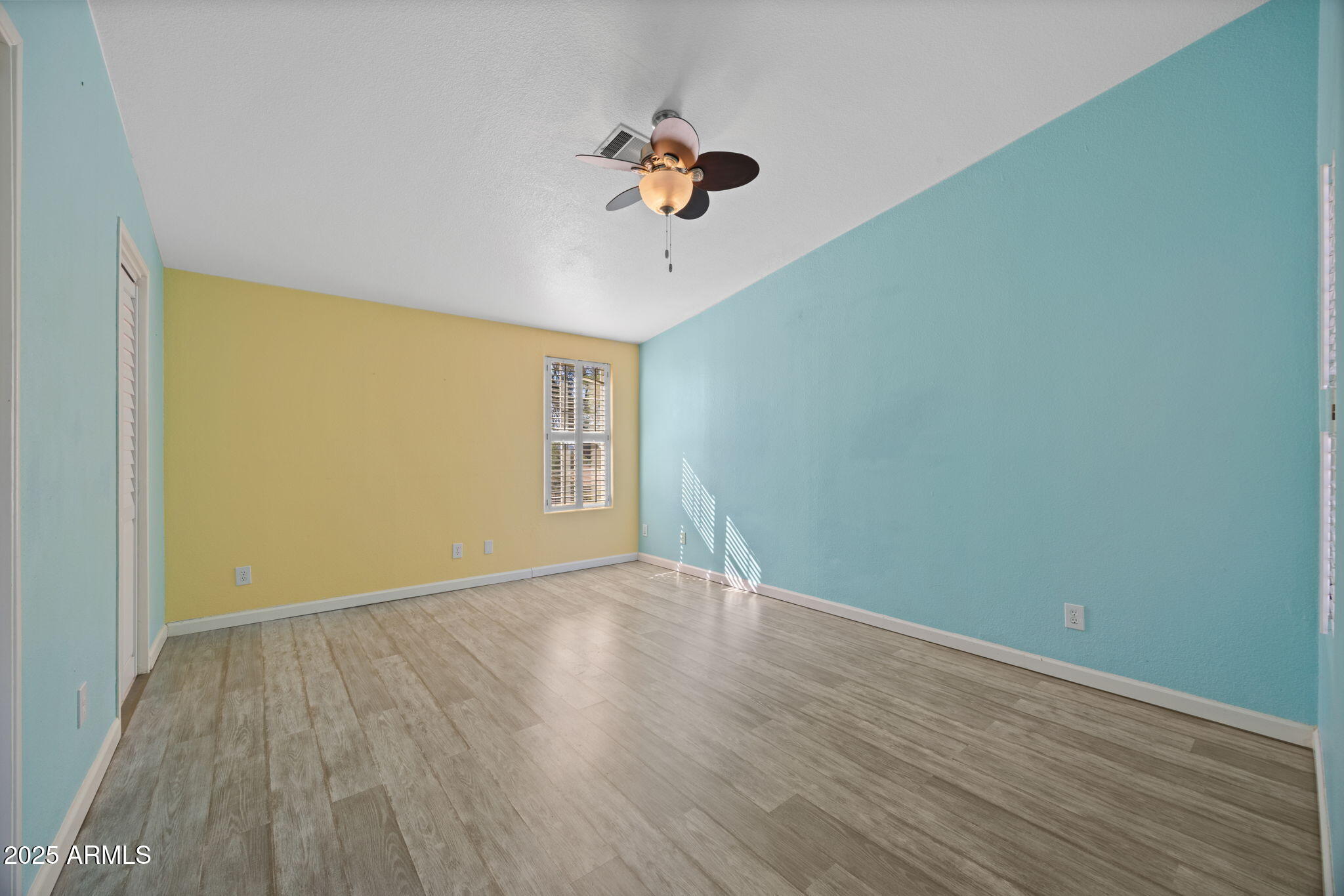 42210 North Castle Hot Springs Road Morristown, AZ 85342 - Photo 14 of 47 a view of a room with wooden floor and a ceiling fan