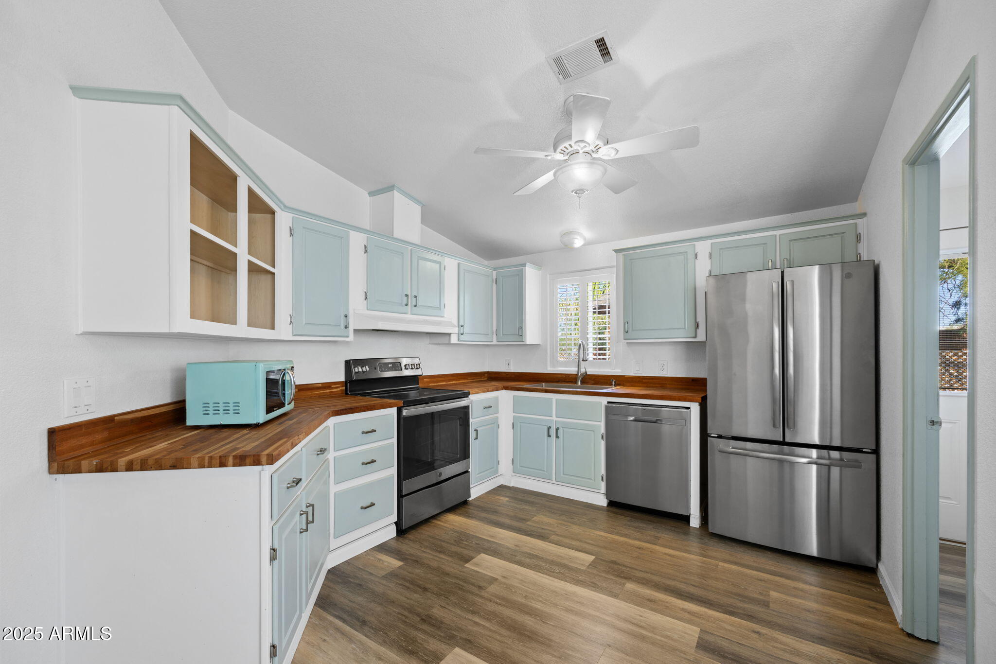 42210 North Castle Hot Springs Road Morristown, AZ 85342 - Photo 20 of 47 a kitchen with stainless steel appliances granite countertop a refrigerator a stove a sink and white cabinets