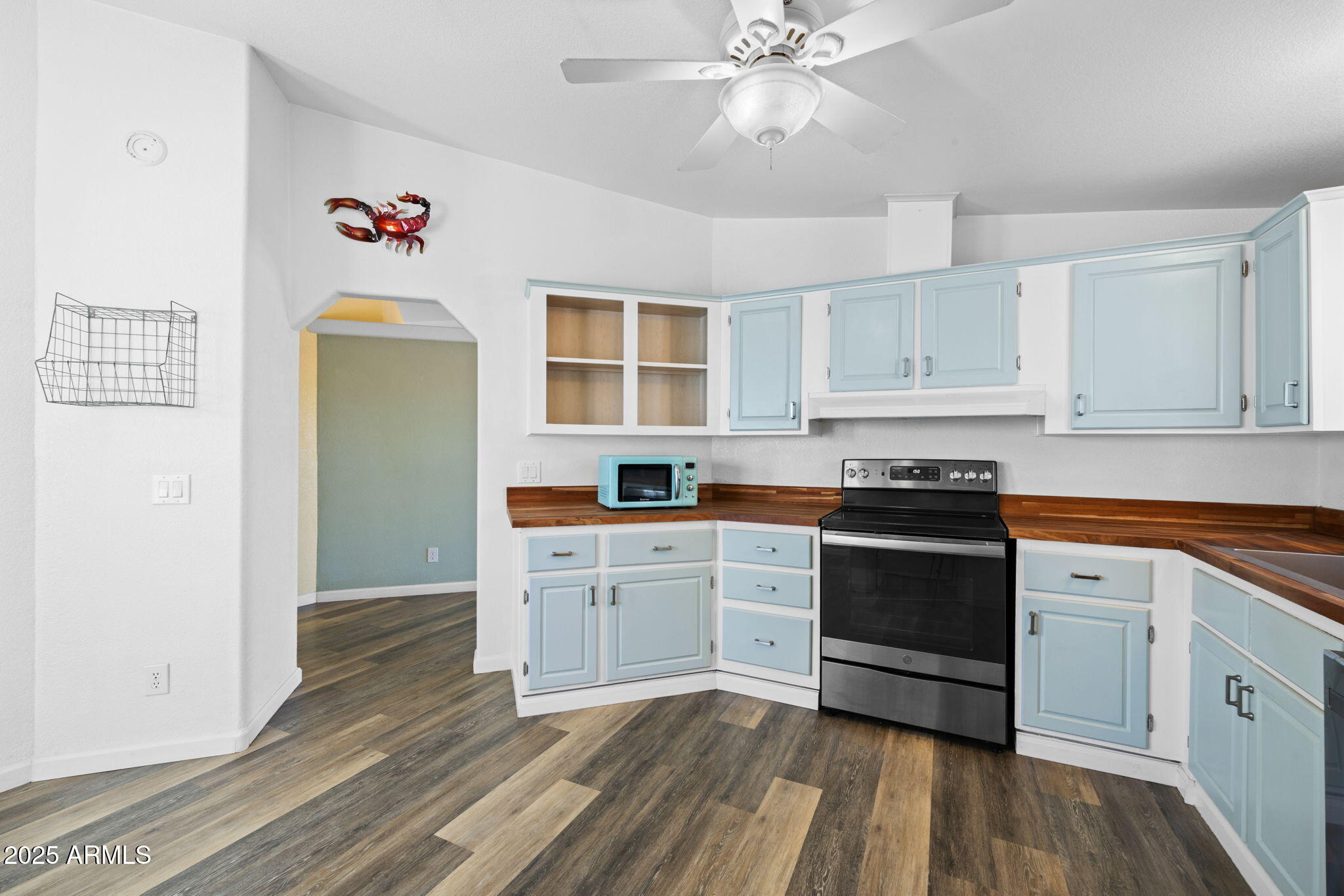 42210 North Castle Hot Springs Road Morristown, AZ 85342 - Photo 22 of 47 a kitchen with granite countertop a stove cabinets and wooden floor