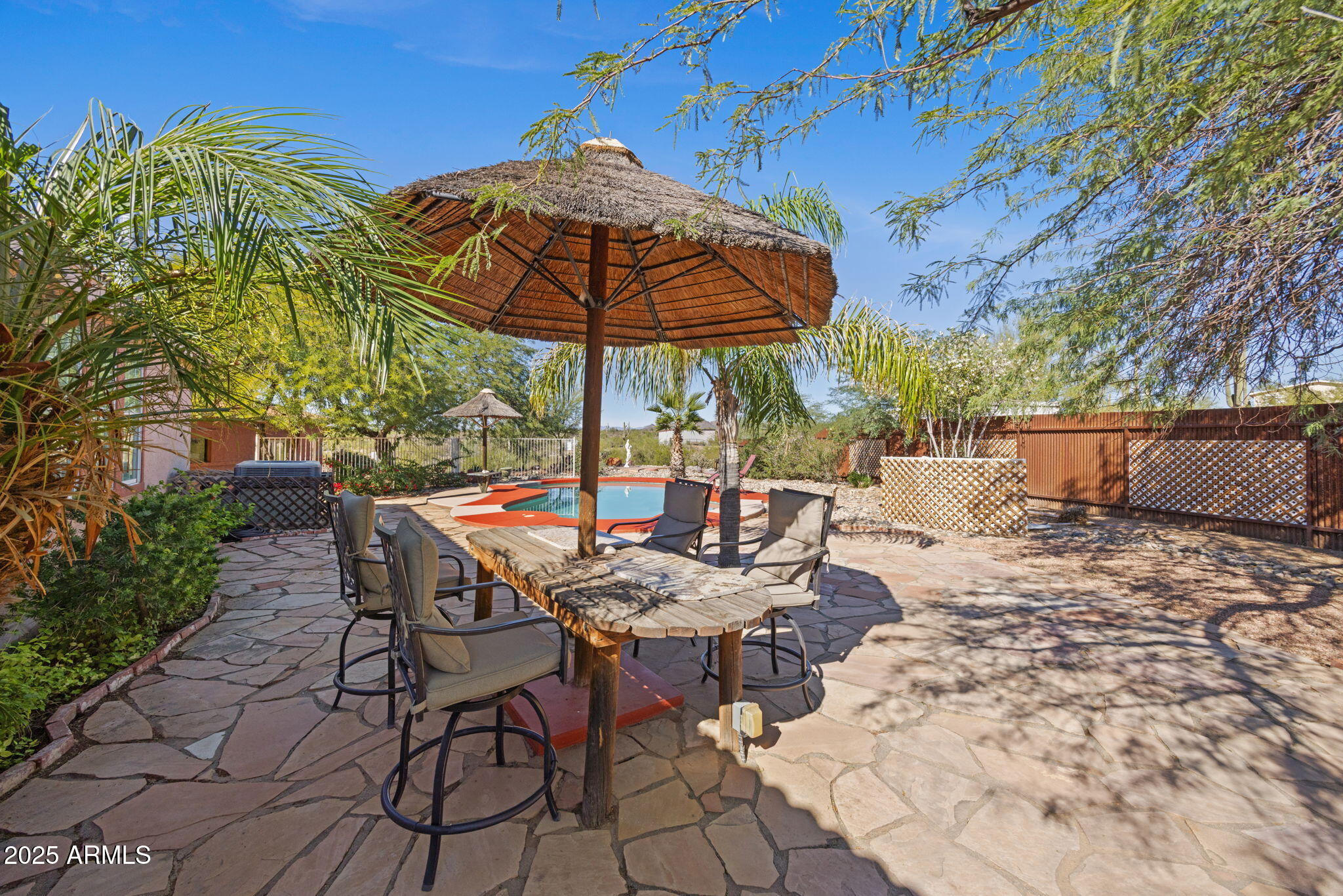 42210 North Castle Hot Springs Road Morristown, AZ 85342 - Photo 27 of 47 a view of backyard with furniture and umbrella