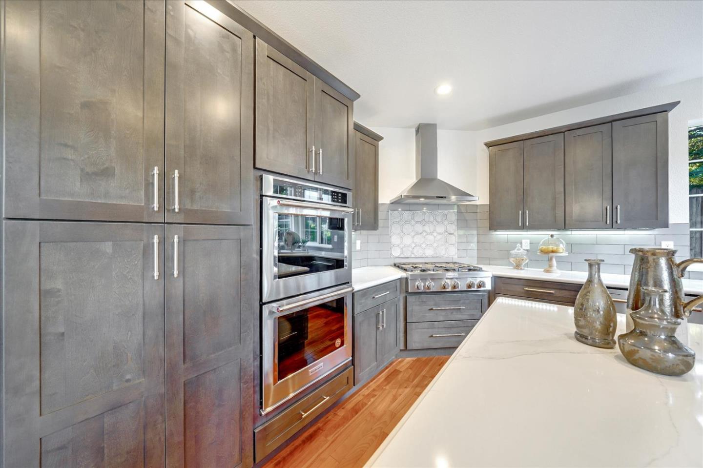 93 Ralston Ranch Road Belmont, CA 94002 - Photo 12 of 49 a kitchen with stainless steel appliances granite countertop a refrigerator and a stove top oven