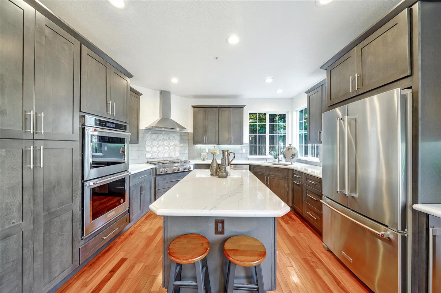 93 Ralston Ranch Road Belmont, CA 94002 - Photo 13 of 49 a kitchen with stainless steel appliances a refrigerator and a stove top oven
