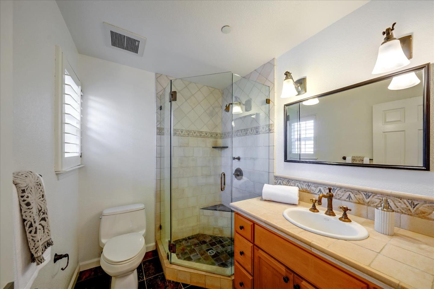 93 Ralston Ranch Road Belmont, CA 94002 - Photo 26 of 49 a bathroom with a sink toilet vanity and shower