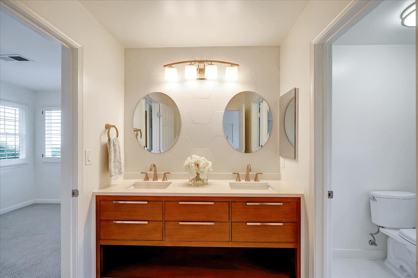 93 Ralston Ranch Road Belmont, CA 94002 - Photo 28 of 49 a bathroom with a double vanity sink and a mirror