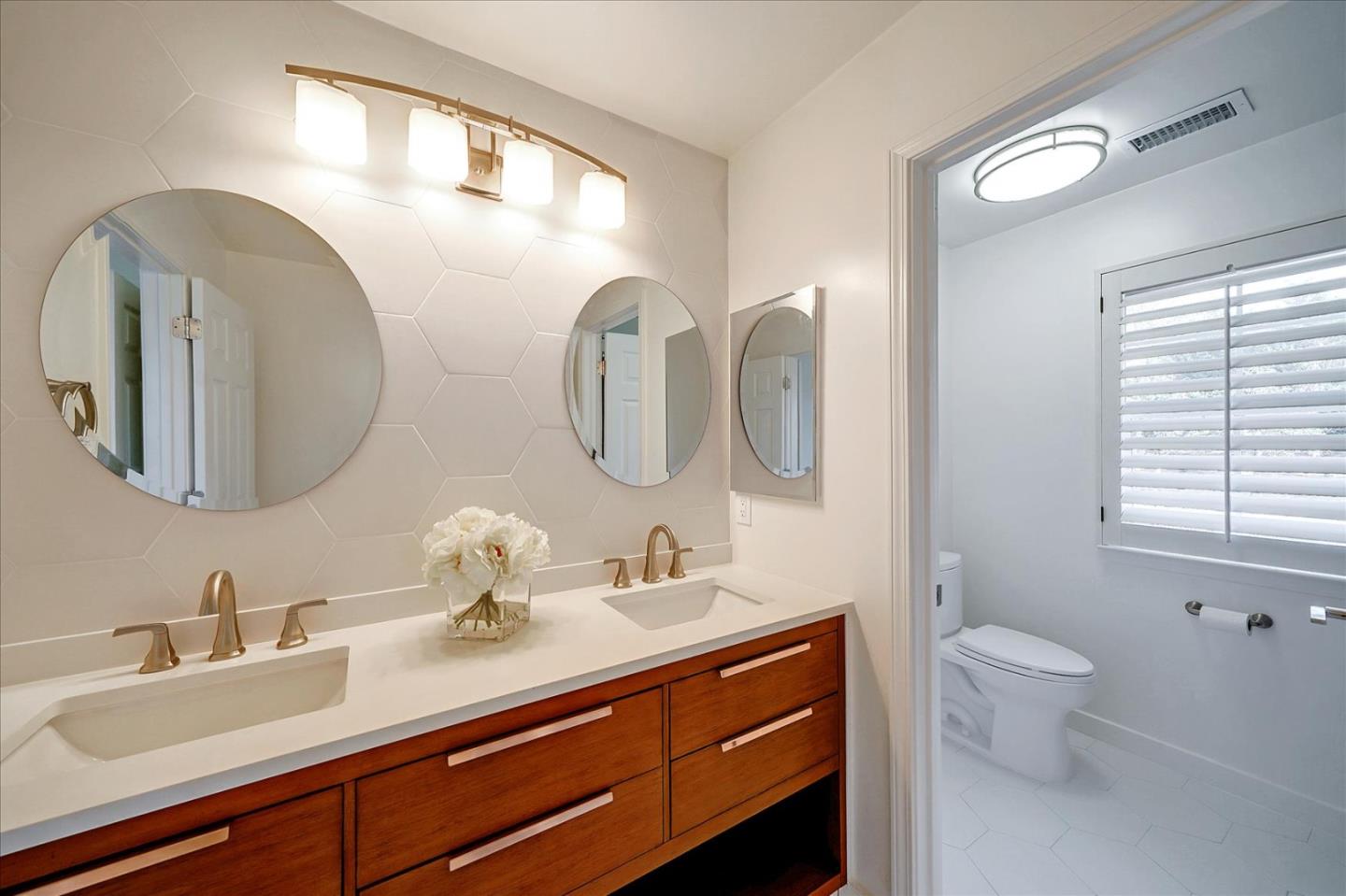 93 Ralston Ranch Road Belmont, CA 94002 - Photo 29 of 49 a bathroom with a double vanity sink mirror and toilet