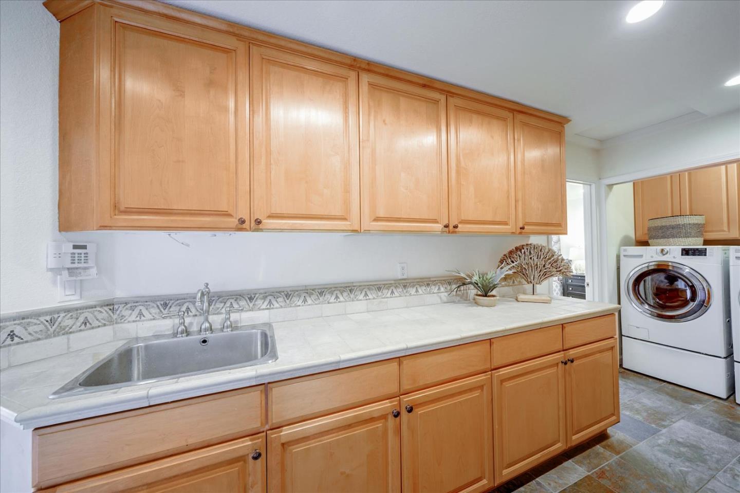 93 Ralston Ranch Road Belmont, CA 94002 - Photo 31 of 49 a kitchen with a sink cabinets and washing machine