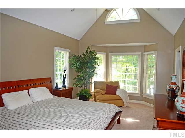 149 Chimney Rise Drive Cary, NC 27511 - Photo 13 of 24 a bedroom with a bed and a large window