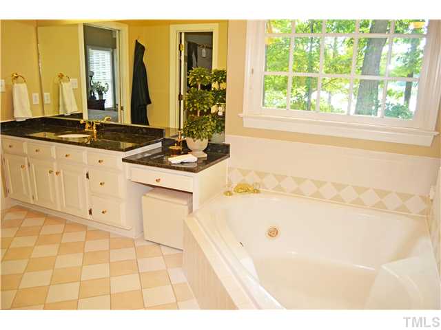 149 Chimney Rise Drive Cary, NC 27511 - Photo 15 of 24 a bathroom with a tub sink and mirror