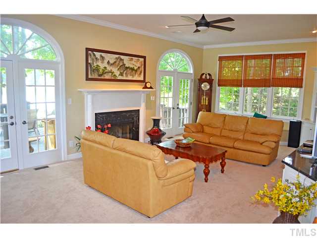 149 Chimney Rise Drive Cary, NC 27511 - Photo 4 of 24 a living room with furniture a fireplace and a large window