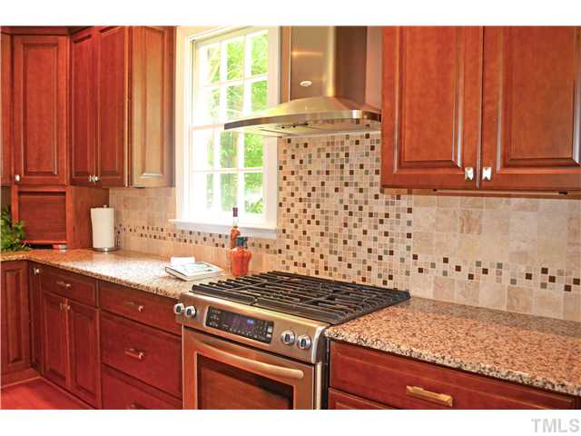 149 Chimney Rise Drive Cary, NC 27511 - Photo 9 of 24 a kitchen with granite countertop cabinets and window