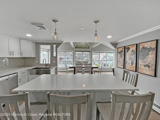 a kitchen with a table chairs stove and wooden cabinets