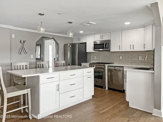 a view of a kitchen with wooden floor and outdoor space