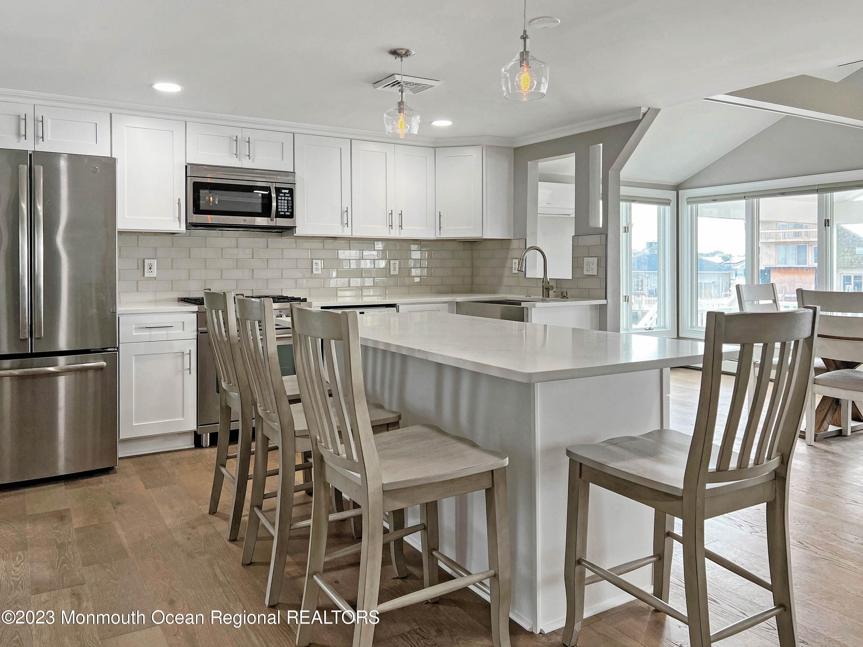 43 Woodhaven Road Toms River, NJ 08753 - Photo 19 of 67 a kitchen with stainless steel appliances granite countertop a dining table chairs refrigerator and microwave