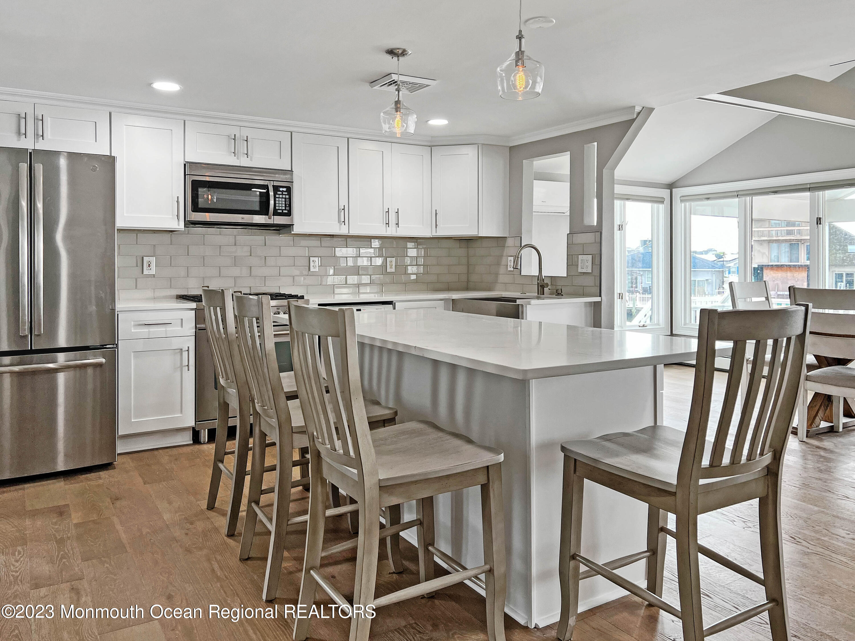 43 Woodhaven Road Toms River, NJ 08753 - Photo 20 of 67 a kitchen with stainless steel appliances granite countertop a dining table chairs refrigerator and microwave