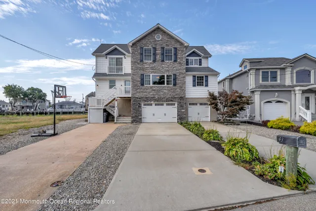 a front view of a house with a garden and fountain