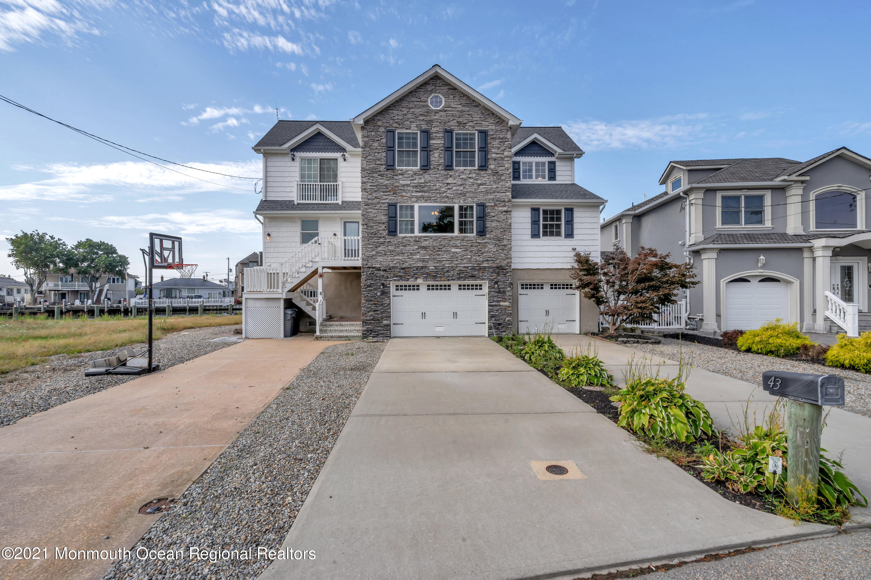 43 Woodhaven Road Toms River, NJ 08753 - Photo 3 of 67 a front view of a house with a garden and fountain