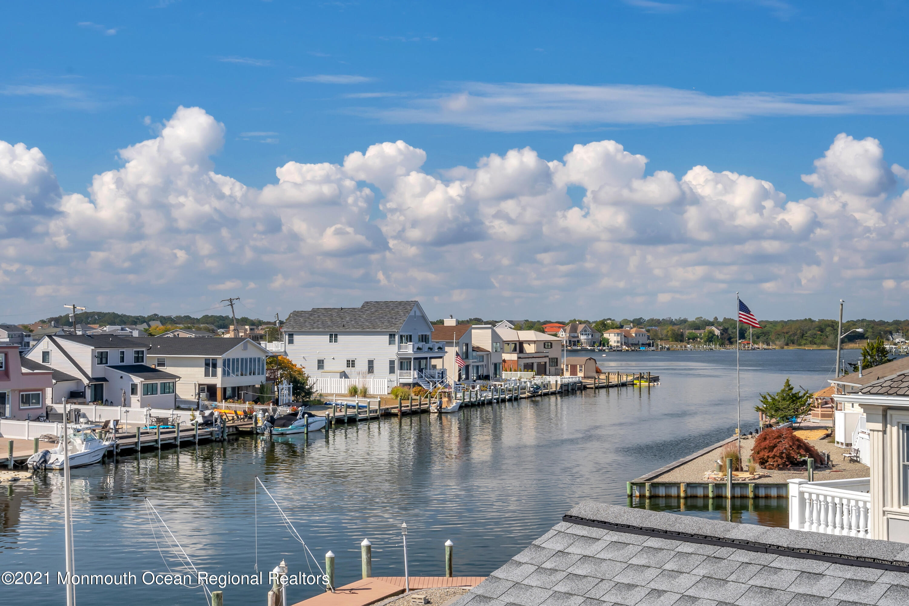 43 Woodhaven Road Toms River, NJ 08753 - Photo 49 of 67 a view of a lake with boats and trees in the background