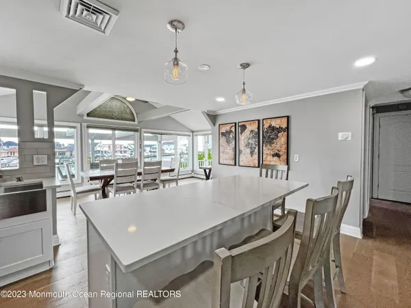 a large white kitchen with a large window