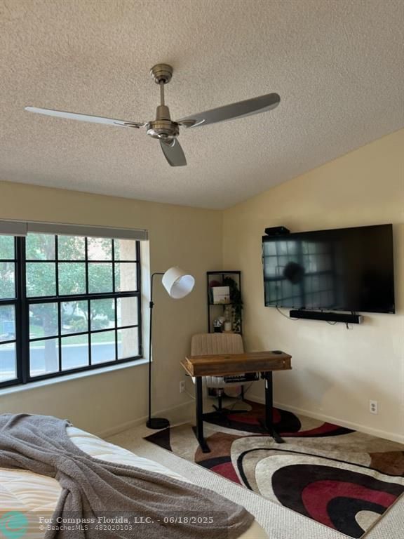 7876 La Mirada Drive Boca Raton, FL 33433 - Photo 11 of 34 a bedroom with furniture and a flat screen tv