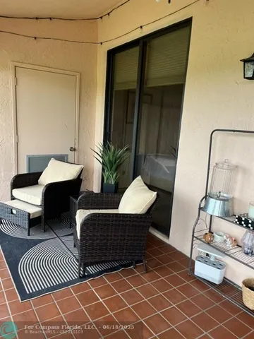 a balcony with chairs and wooden floor