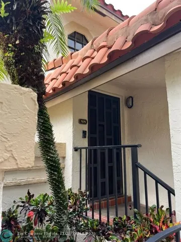 a view of a potted flower in front of a house
