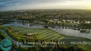 7876 La Mirada Drive Boca Raton, FL 33433 - Photo 23 of 34 a view of a lake in between two of trees