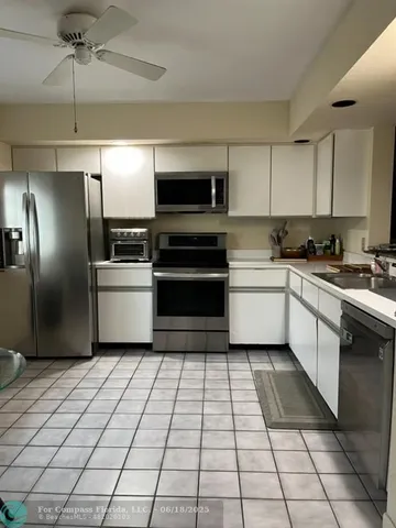 a kitchen with a sink stainless steel appliances and cabinets