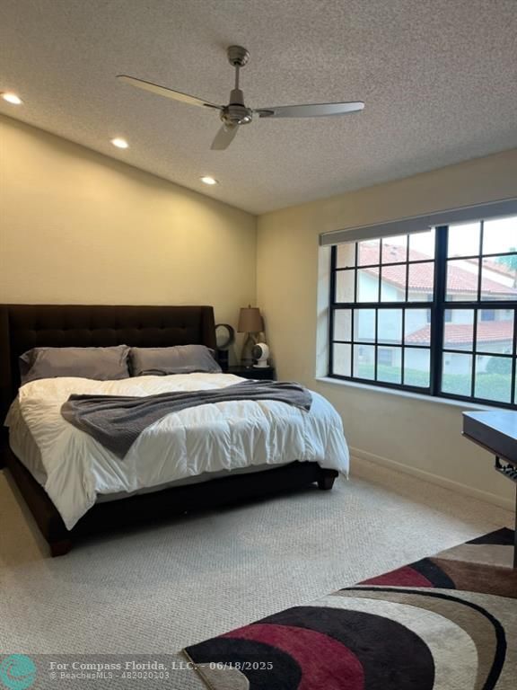 7876 La Mirada Drive Boca Raton, FL 33433 - Photo 10 of 34 a bedroom with a large bed and a large window