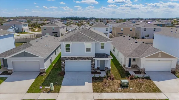 an aerial view of a house with a yard