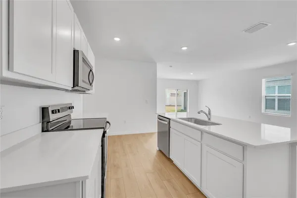 a kitchen with stainless steel appliances granite countertop a sink and cabinets