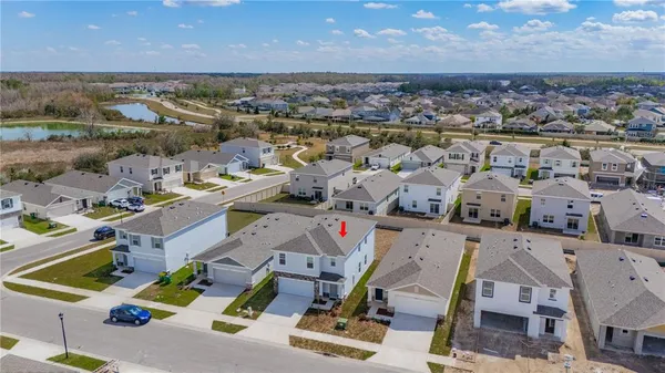 an aerial view of residential houses with outdoor space