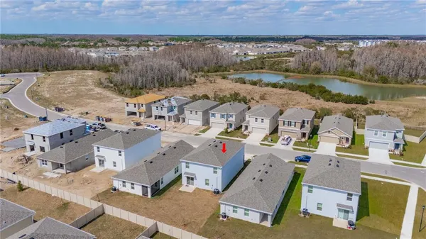 an aerial view of residential house with outdoor space and lake view