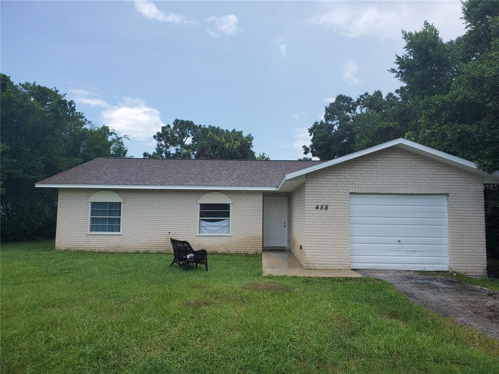 458 Spring Drive Ocala, FL 34472 - Photo 1 of 1 a house view with a backyard space
