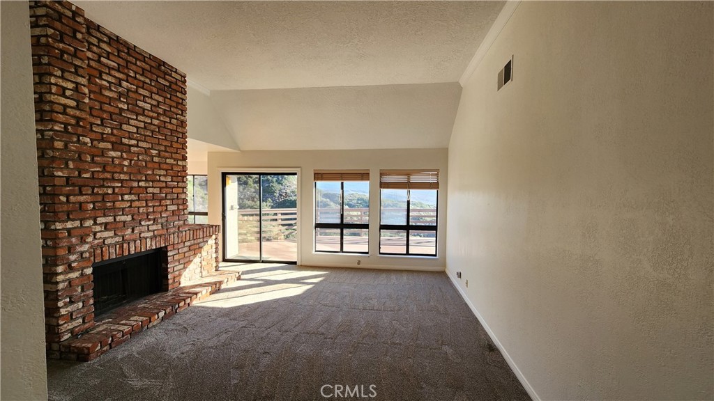 750 Avenida Acapulco San Clemente, CA 92672 - Photo 13 of 25 a view of an empty room with a fireplace and a window