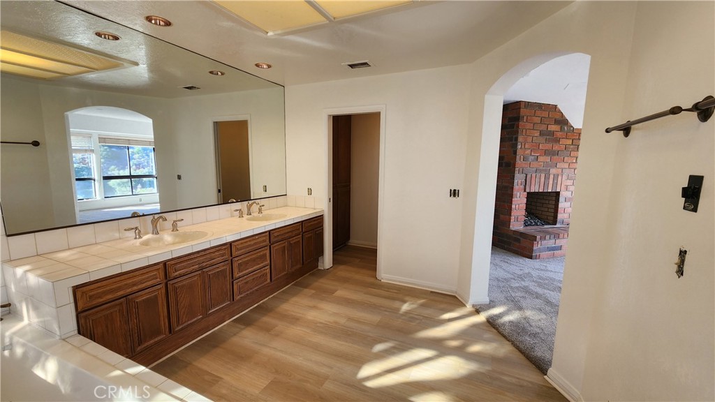 750 Avenida Acapulco San Clemente, CA 92672 - Photo 22 of 25 a spacious bathroom with a double vanity sink a large mirror and a shower