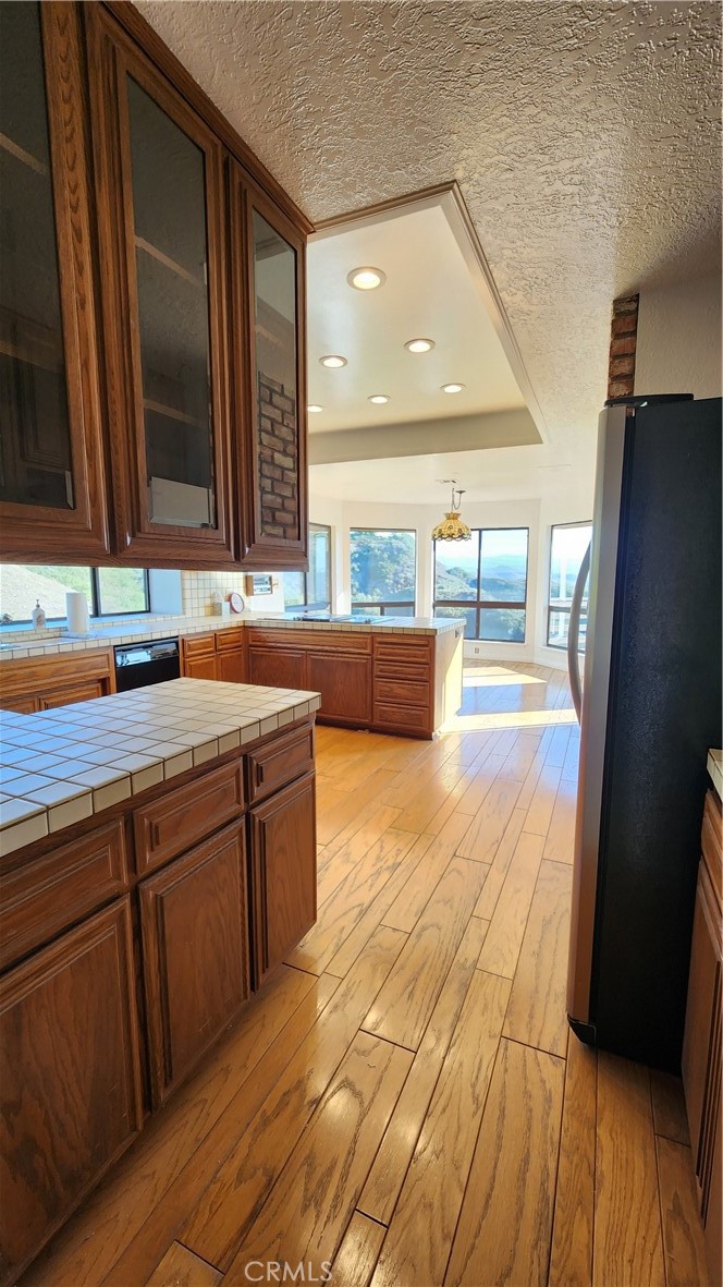 750 Avenida Acapulco San Clemente, CA 92672 - Photo 9 of 25 a kitchen with wooden cabinets and a wooden floor