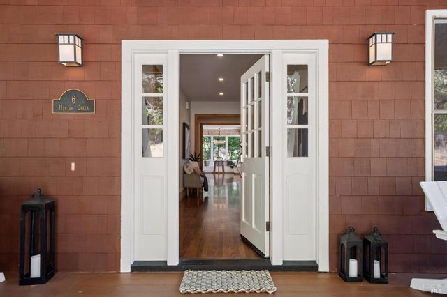 a large kitchen with stainless steel appliances granite countertop a stove and a large window