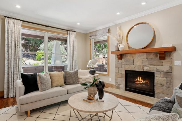 a living room with furniture a fireplace and a flat screen tv