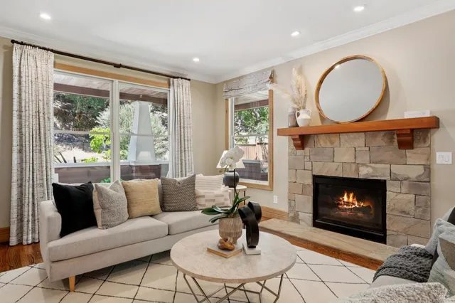 a living room with furniture a fireplace and a flat screen tv