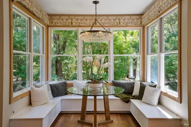 a view of a hallway with wooden floor and windows