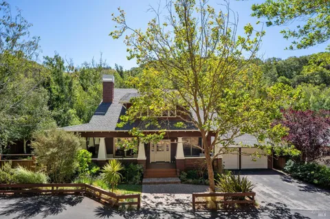 a backyard of a house with plants and outdoor seating