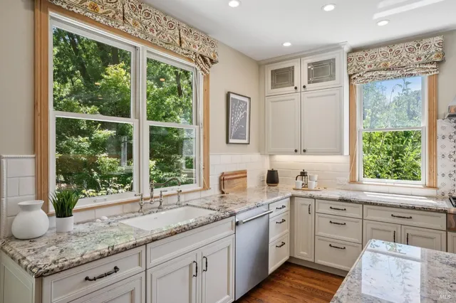 a view of a workspace with furniture and a window
