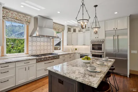 a bedroom with furniture and a large window