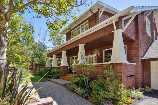 a living room with a large window wooden floor and a table