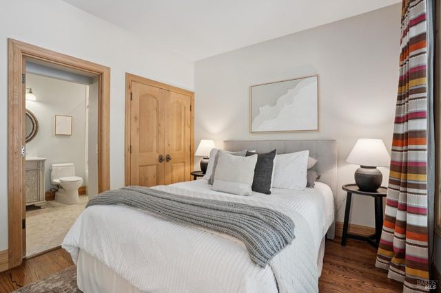 a view of a tennis ground with large trees