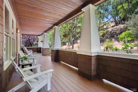 a living room with furniture fireplace and a large window